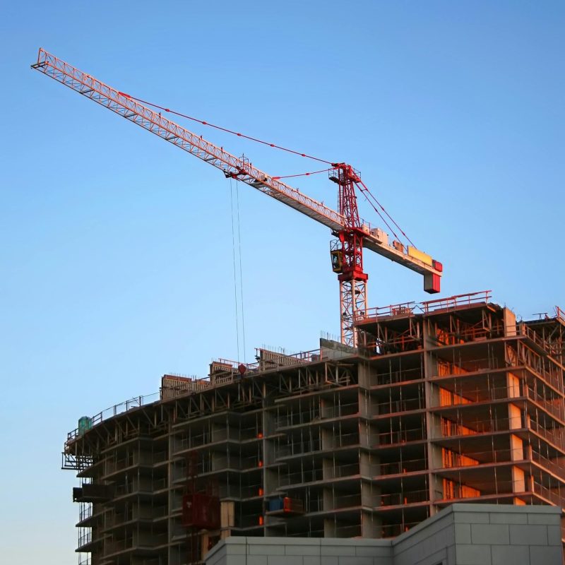 pexels-photo-93400-93400 Tower crane on a high-rise building under construction at sunset, showcasing modern urban development.